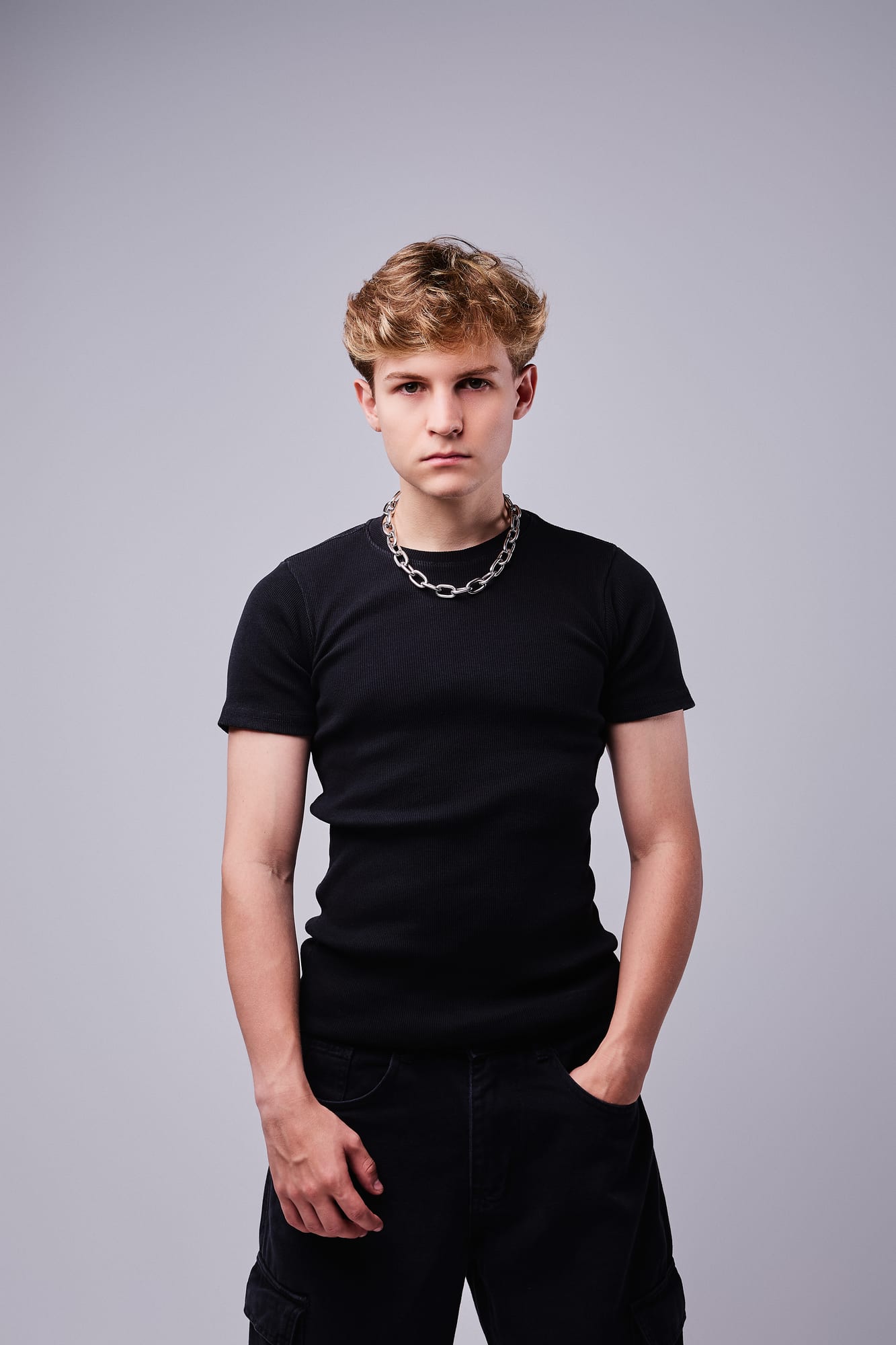 Front-facing studio portrait of Brazilian DJ and producer BUJA wearing black